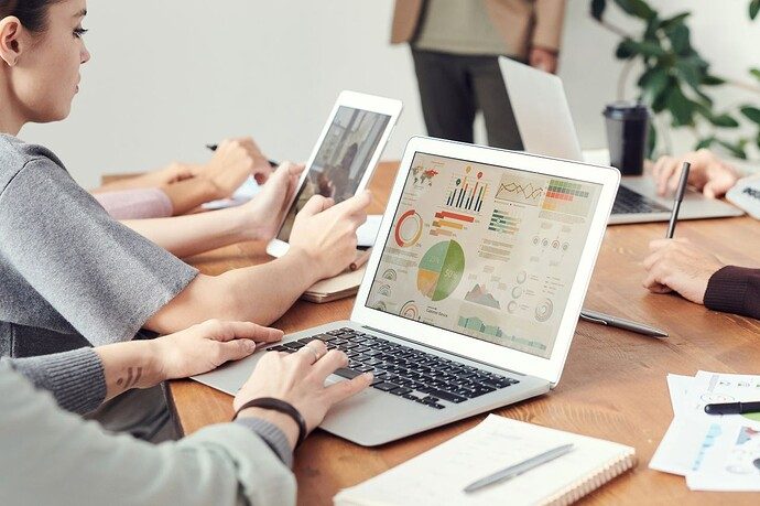 Credit: Pexels by fauxels Coworkers analyzing data charts on laptops during a team meeting